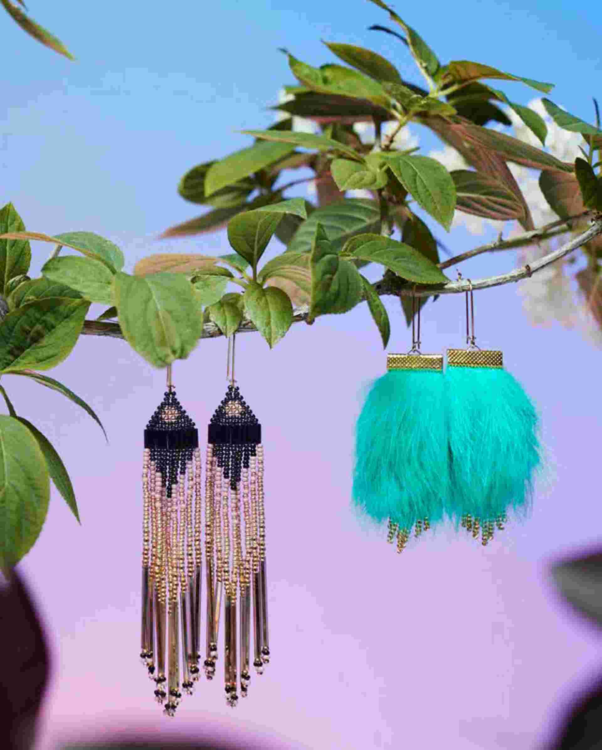 fluffy earrings hanging on a tree branch