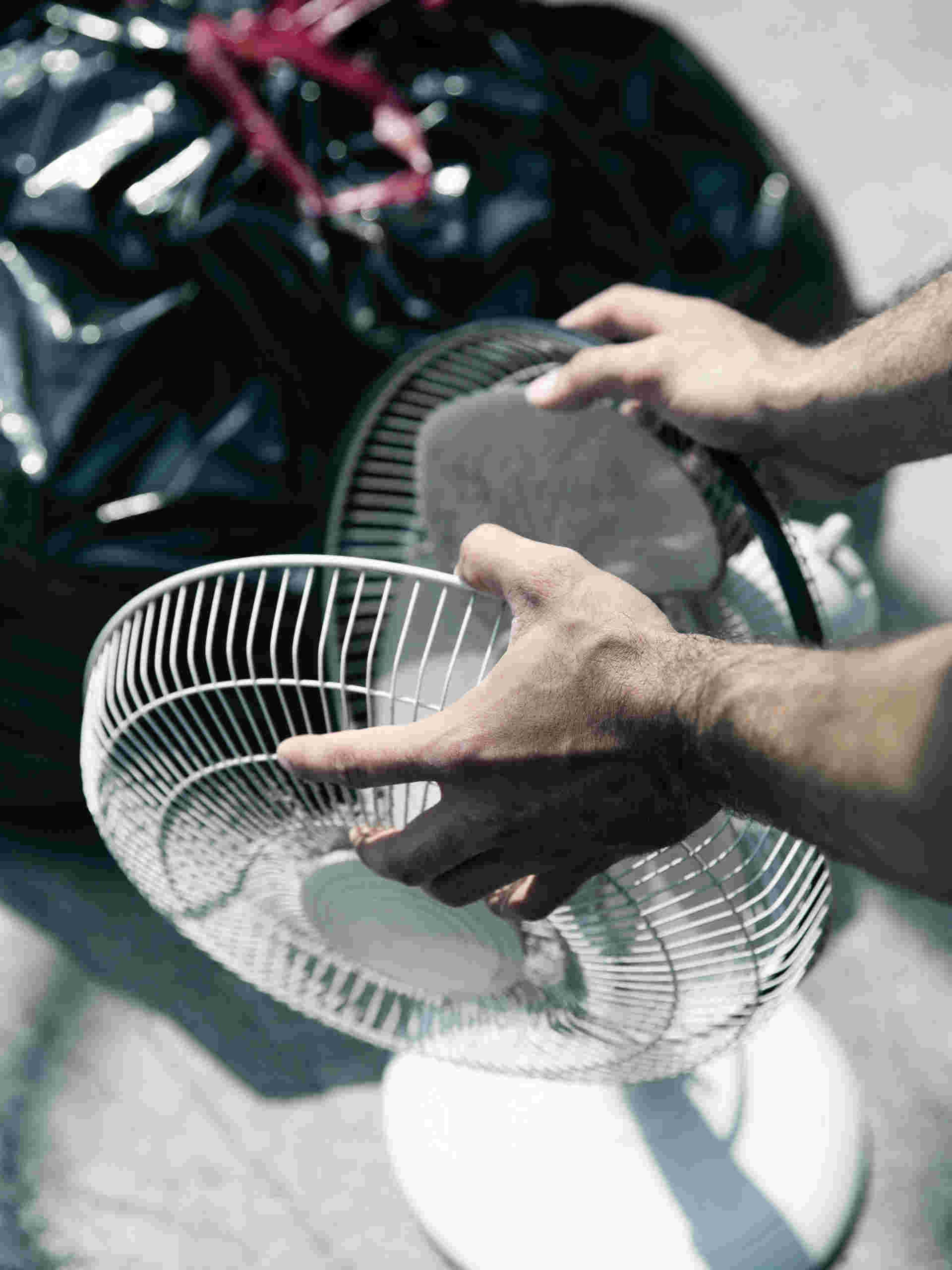 hands opening a fan to reveal what's inside