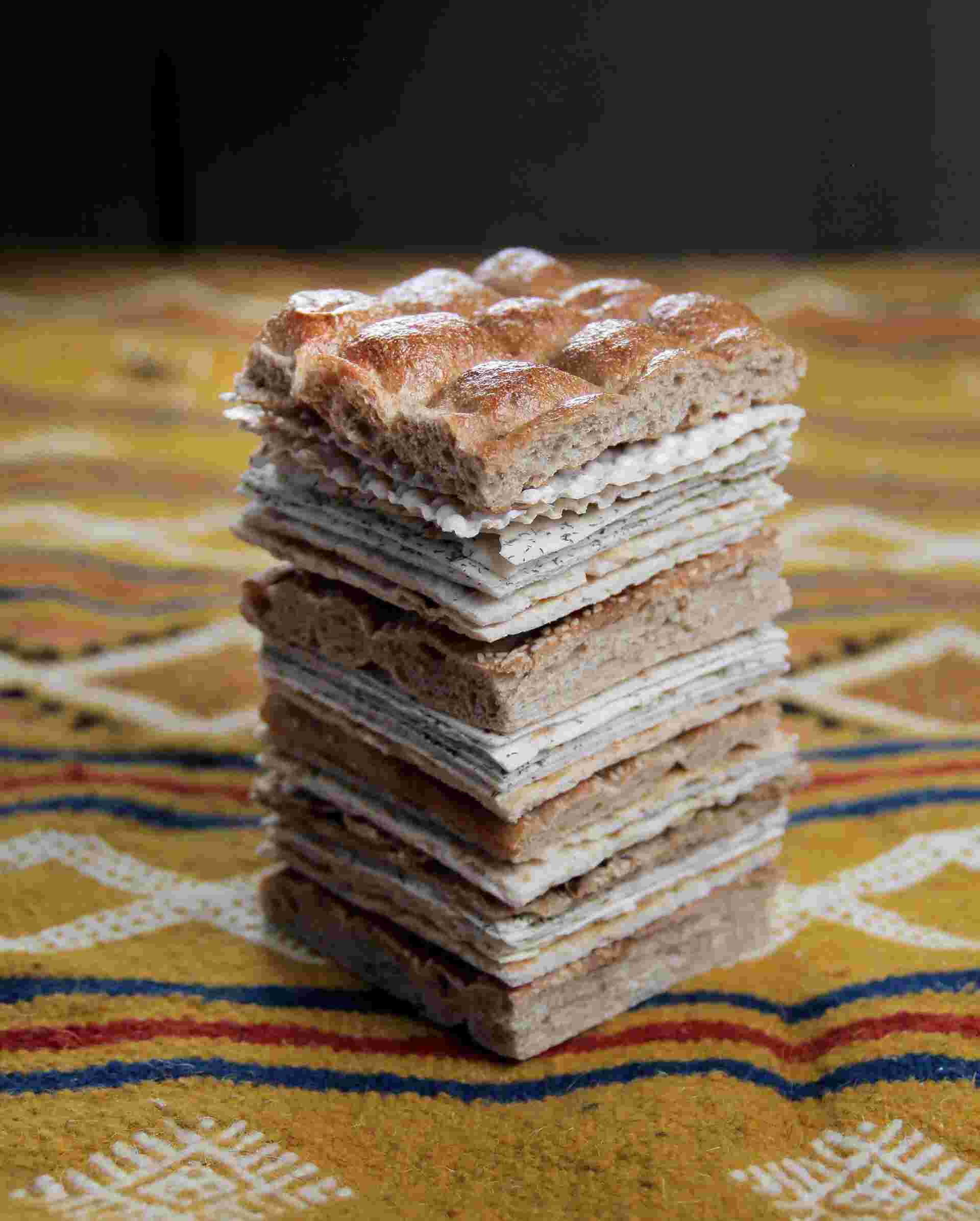 Flatbreads by Sameer Farooq - 12-Stack-of-layered-bread-slices-on-a-patterned-tablecloth