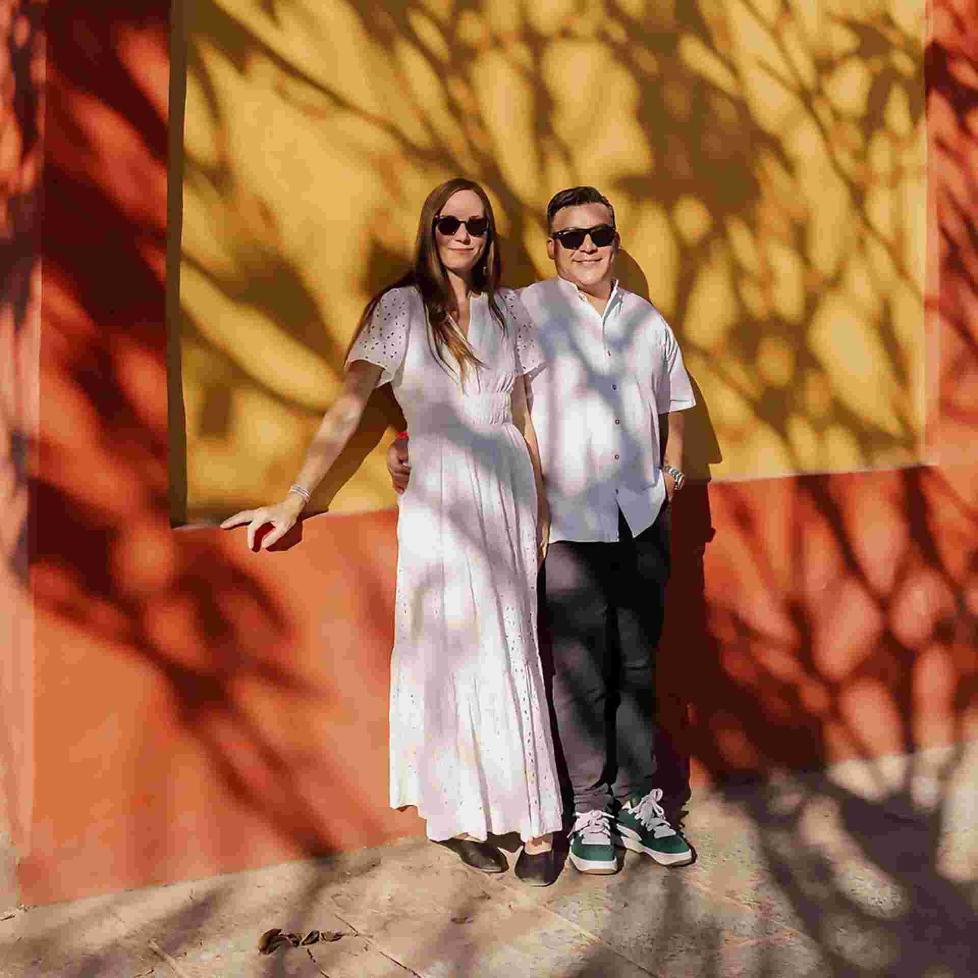 Family Meal - 19-couple_in_white_clothing_against_yellow_wall_with_tree_shadows