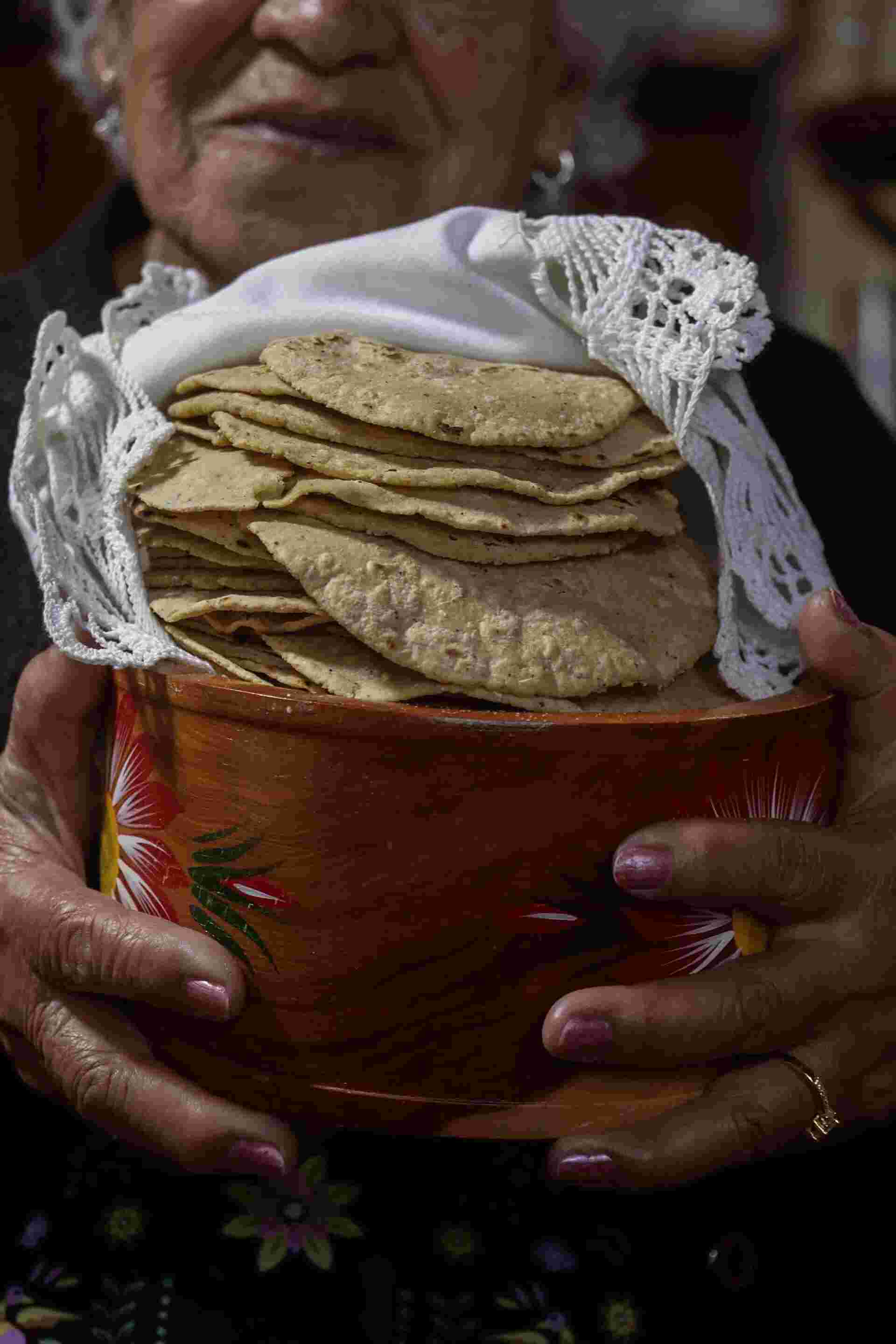 Family Meal - 24-Elderly-woman-holding-a-basket-of-homemade-tortillas