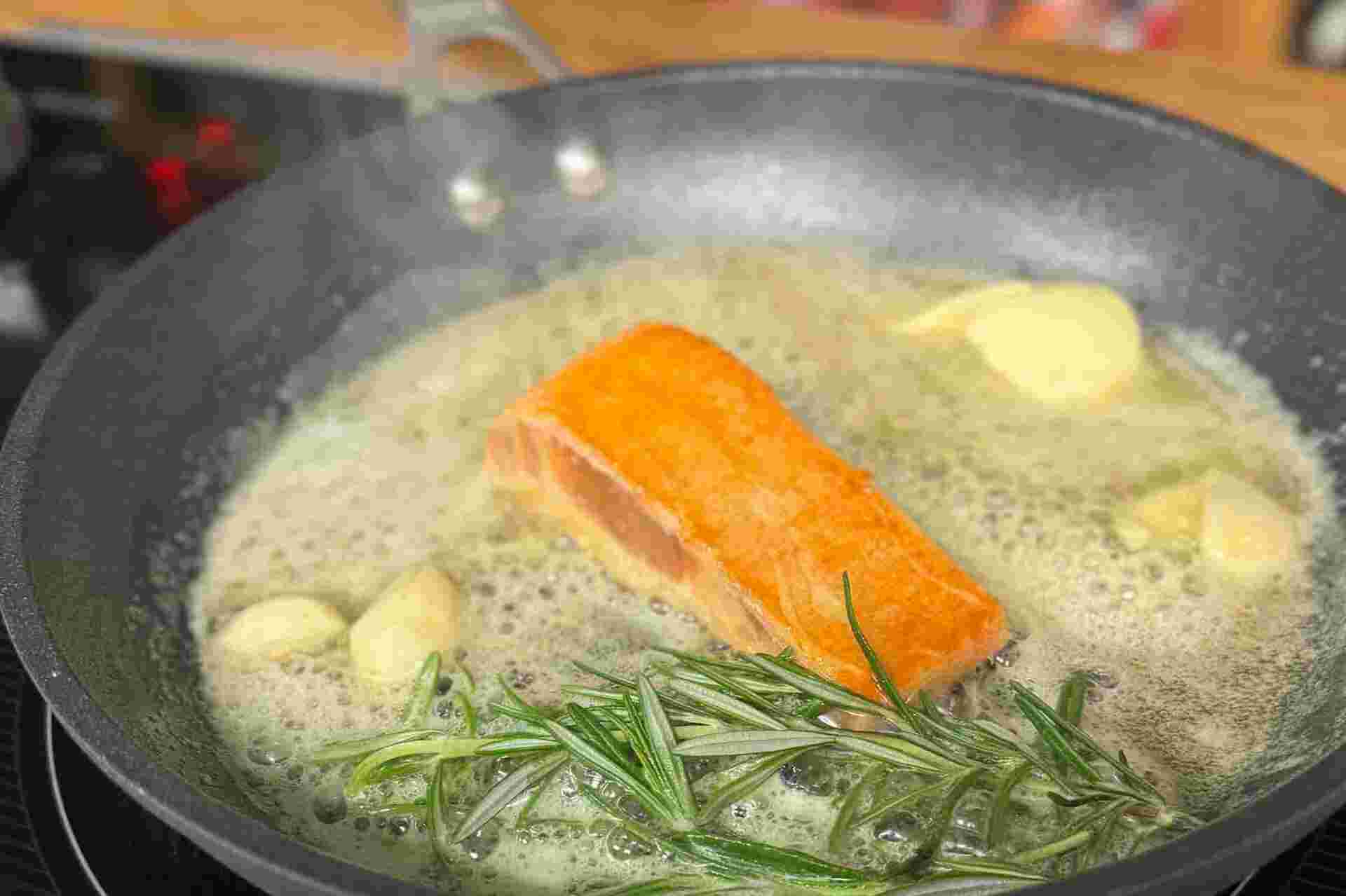 Plant-based Salmon by New School Foods - 32-Salmon-fillet-cooking-in-a-pan-with-butter-garlic-and-rosemary