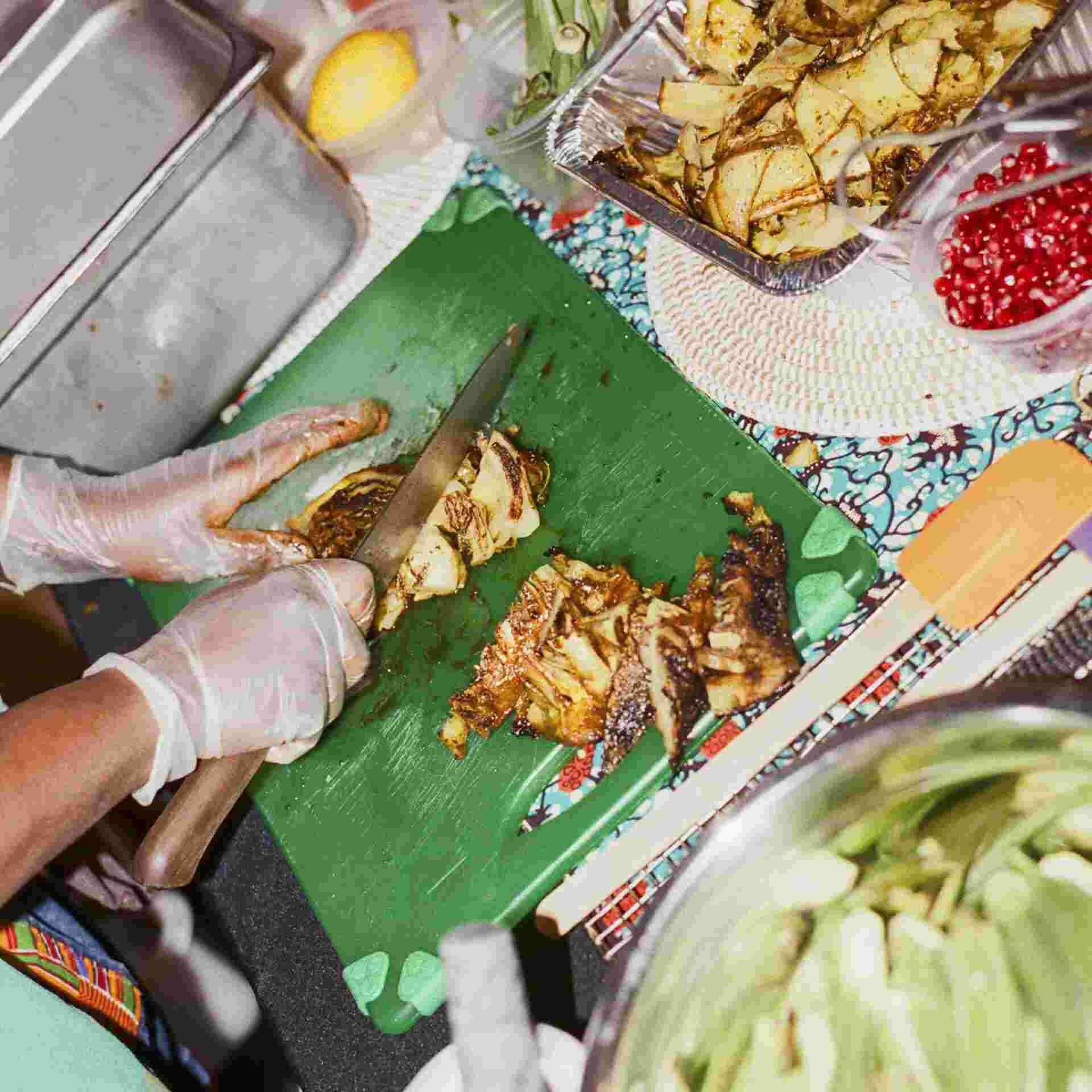 2025-02-11 13:26 EST - 6-overhead_view_chopping_board_with_charred_cabbage_okra_and_spice_containers